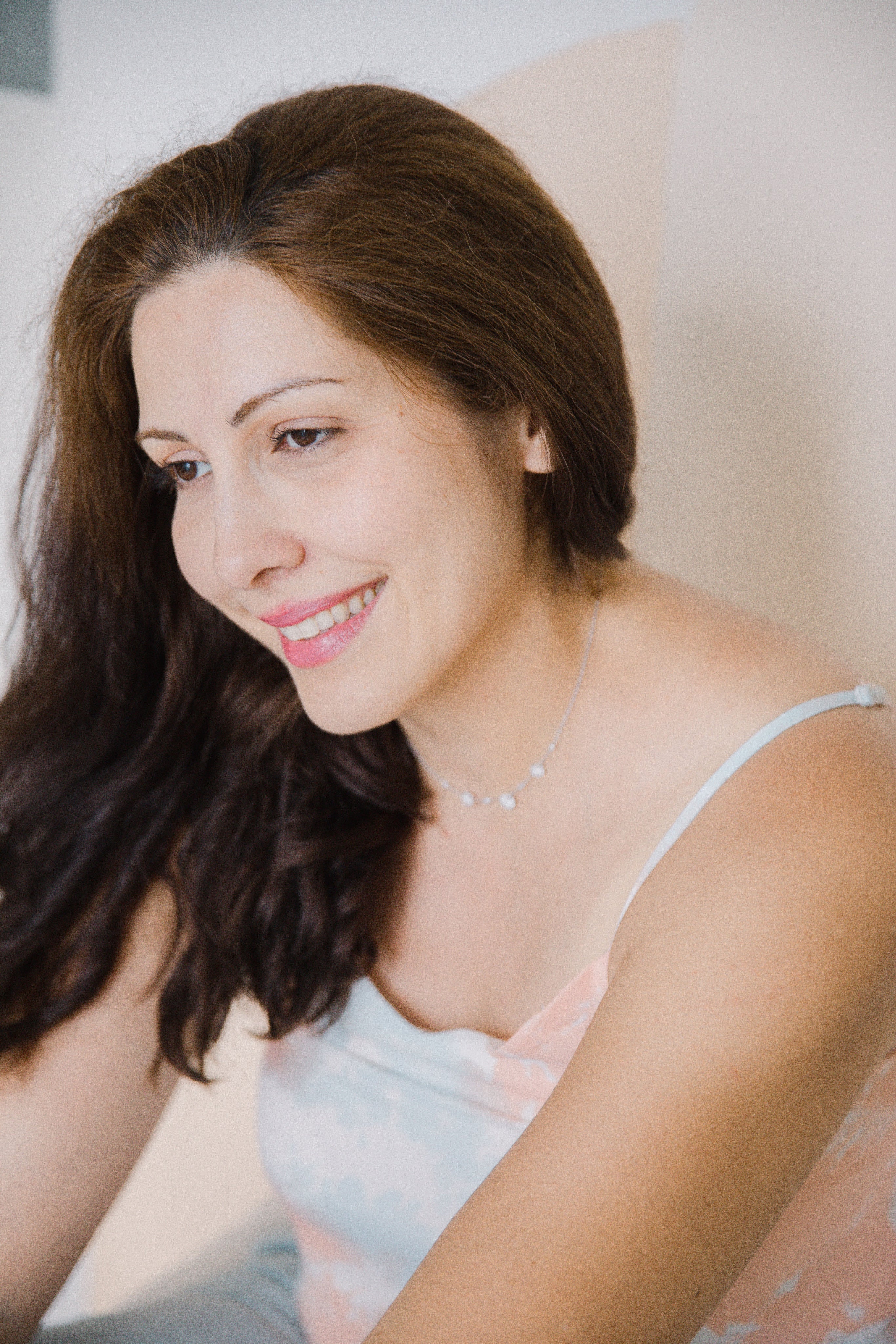 files/portrait-of-person-with-long-brown-hair-smiling-in-white.jpg